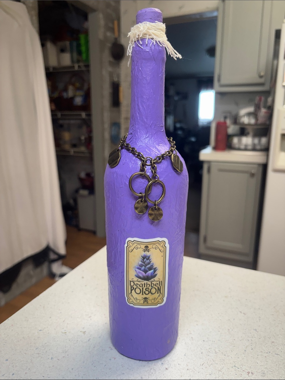 Decorative Purple Bottle with Brass Charm Accent